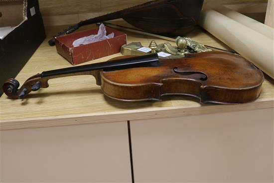 A violin, bow and a mother of pearl inlaid mandolin